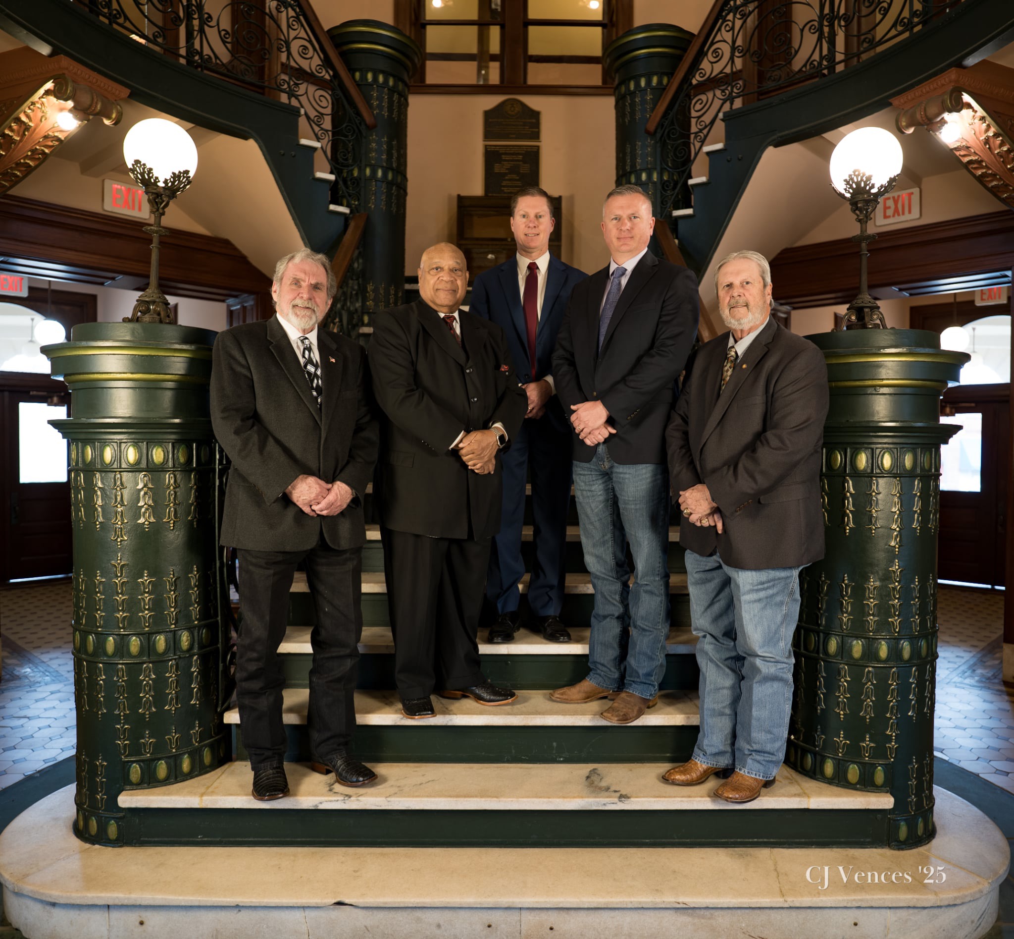 Harrison County Judge and Commissioners posing on stairs