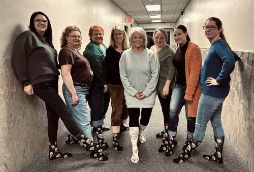 District Clerks office staff posing with matching socks